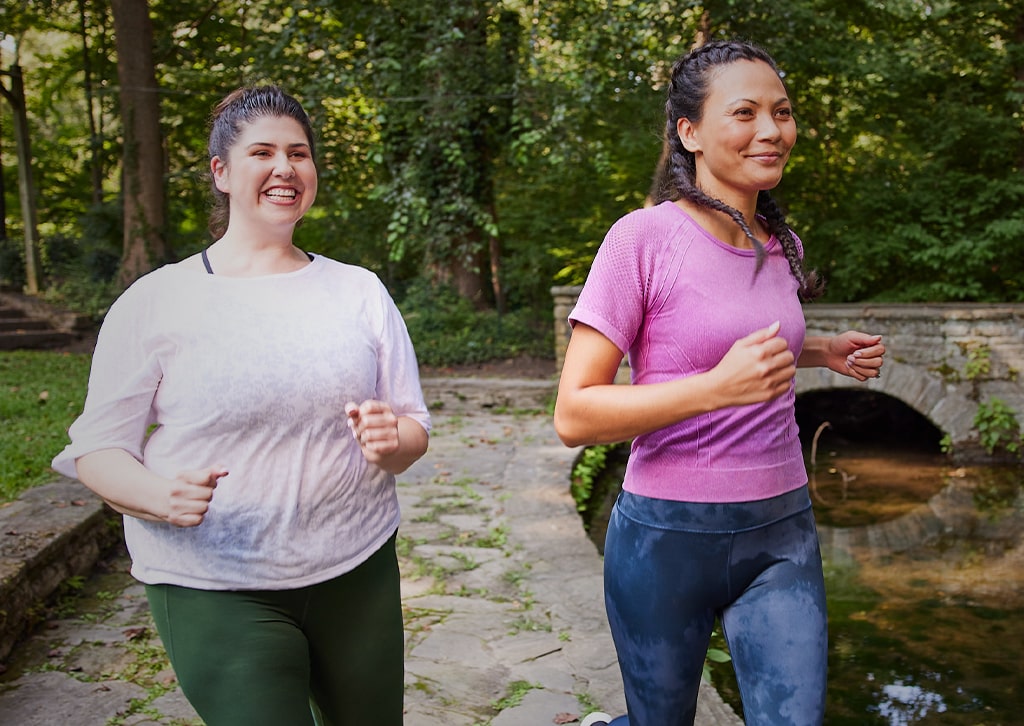 Woman running in the park practicing the habit of healthy motion.