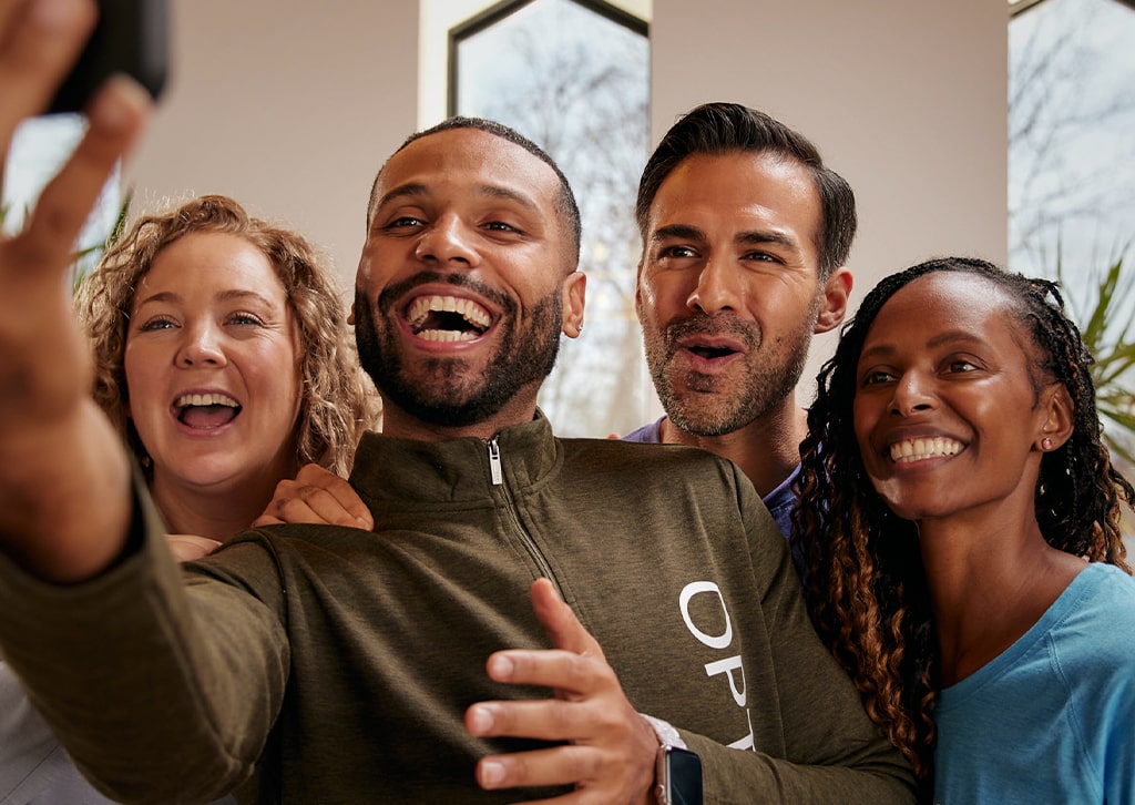 Group of four people in the Optavia Community posing for a selfie, smiling.